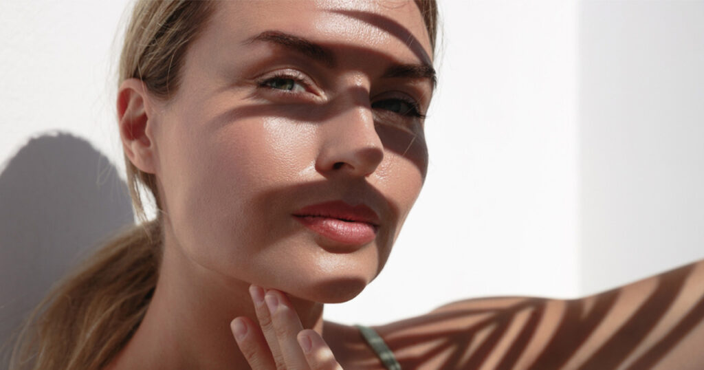 The woman is saving her face from the sun